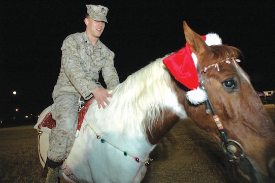 Cpl. Jeremy Grill, Headquarters and Headquarters Squadron travel claims noncommissioned officer-in-charge and native of Ashland, Wis., takes a ride on Bandcamp Dec. 16 on the station parade field as part of the Ho, Ho, Ho Down. The event combined a holiday party with a traditional country get-together, providing Marines, sailors and their families a fun-filled night, complete with clowns, live music, free food and raffles throughout the night. Face painting and balloon animals were also offered to children during the event. Santa Claus, who was escorted by the Marine Corps Air Station Yuma Fire Department in one of its fire trucks, even made a surprise visit.