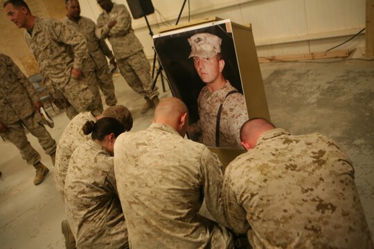 Marines with Motor Transportation Company, Combat Logistics Battalion 5, 1st Marine Logistics Group, remember a fellow Marine who died in a combat zone while serving here. A memorial service was held here Dec. 27 for Lance Cpl. Robert L. Johnson, 21, a MT operator from Central Point, Ore.