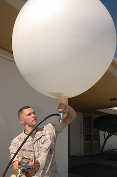 Lance Cpl. Darien Garland, Marine Wing Support Squadron 371 weather observer and native of Albany, N.Y., fills a sonde, or weather balloon, with helium outside Station Meteorological Oceanographic Command Oct. 11. Station METOC doesn?t send up sondes often, and when they do, it is mostly for training purposes, but Marines keep in practice in case of deployment. The sonde collects information such as wind speed, direction, temperature and humidity at different heights and sends the information back to the Marines in order for them to more accurately forecast the weather.