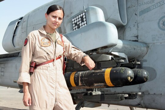 AL ASAD, Iraq ? Captain Jessica M. Moore, an AH-1 Cobra pilot with Marine Light Attack Helicopter Squadron 167, poses in front of one of the aircraft she pilots.  Moore was recently named one of the 2005 Military Women of Merit by the North County Times, a large San Diego area newspaper.