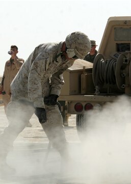 Pfc. Joseph Fox blows sand and dirt from the deck of the newly installed marshalling pad at Al Asad, Iraq, April 21. Fox is an expeditionary airfield systems technician with Marine Wing Support Squadron 274, Marine Wing Support Group 37 (Reinforced), 3rd Marine Aircraft Wing. He is an Eads, Tenn., native.
