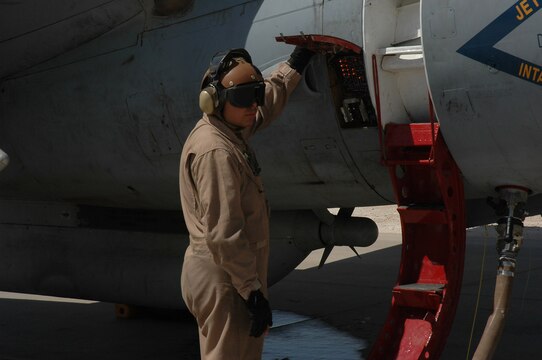 Lance Cpl. Daniel J. Calderon III, waits by a EA-6B Prowler while it is refueling Aug. 31 at Al Asad, Iraq. Calderon is an EA-6 fixed-wing mechanic with Marine Tactical Electronic Warfare Squadron 3, Marine Central Command. The Marines with VMAQ-3 have adopted a new fueling process that greatly reduces the time an aircraft is on the ground.