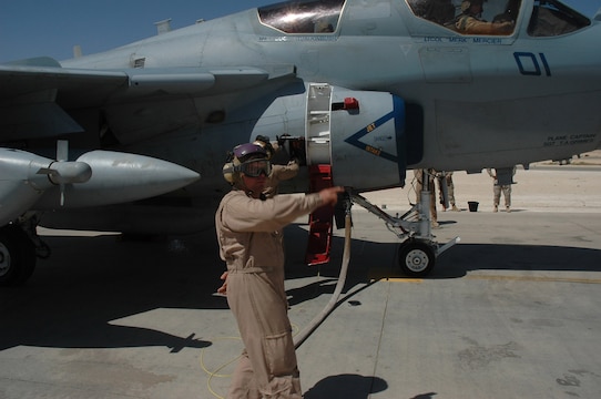 Cpl. Logan Mulkey signals a fuel truck to stop pumping Aug. 31 at Al Asad, Iraq. Mulkey, a bulk fuels specialist with Marine Wing Support Squadron 274, Marine Wing Support Group 37 (Reinforced), 3rd Marine Aircraft Wing (Forward), is assisting in a refueling of an EA-6B Prowler before sending it back out to continue its mission.