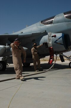 Cpl. Logan Mulkey signals a fuel truck to stop pumping Aug. 31 at Al Asad, Iraq. Mulkey, a bulk fuels specialist with Marine Wing Support Squadron 274, Marine Wing Support Group 37 (Reinforced), 3rd Marine Aircraft Wing (Forward), is assisting in a refueling of an EA-6B Prowler before sending it back out to continue its mission.