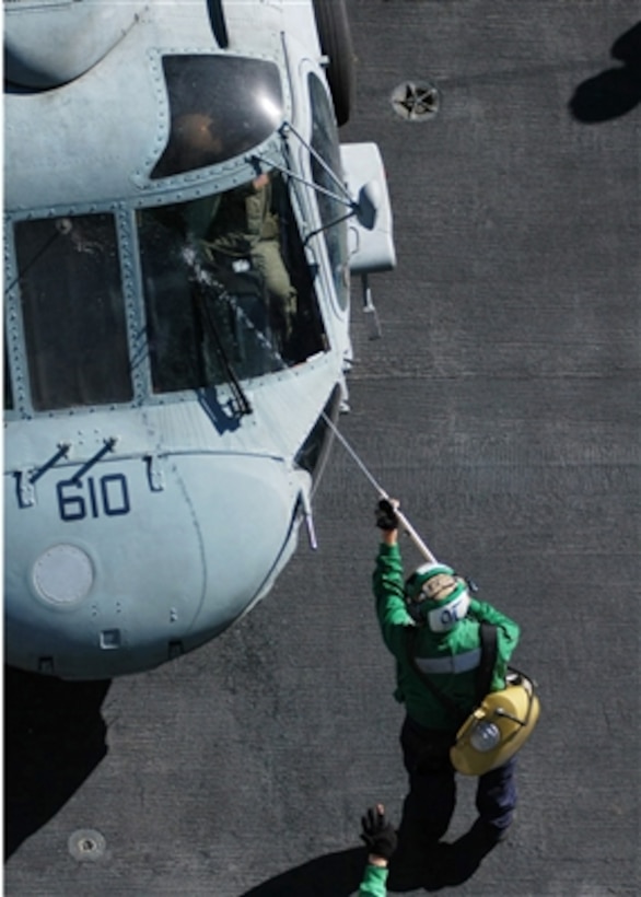 A U S Navy Sailor Washes Off The Windshield Of An Sh F Seahawk