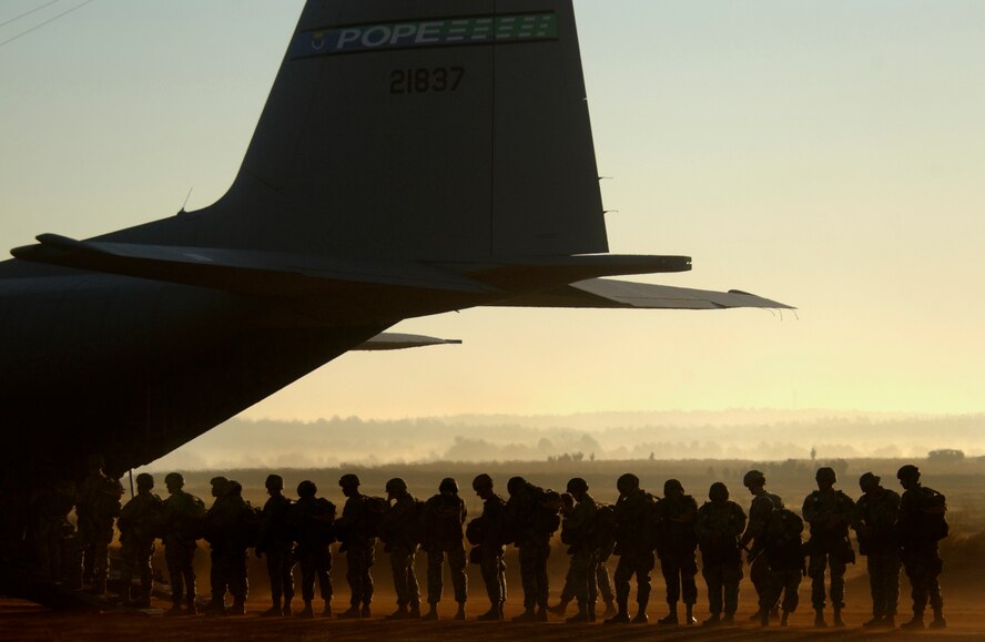 Army paratroopers from the 82nd Airborne Division board a C-130 Hercules during the 9th Annual Randy Oler Memorial Operation Toy Drop Dec. 16, at Fort Bragg, N.C. Soldiers participate in the operation by donating a toy in exchange for a chance to make a non-tactical parachute jump with German or Australian jumpmasters. (U.S. Air Force photo/Tech. Sgt. Adrian Cadiz)