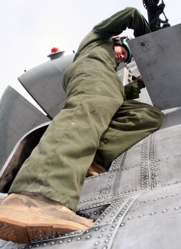 Cpl. James B. Blend repairs a panel on a CH-46 Sea Knight helicopter Feb. 21 at Al Taqaddum, Iraq. Blend is an airframes mechanic and San Antonio, native with Marine Medium Helicopter Squadron 161, Marine Aircraft Group 16, 3rd Marine Aircraft Wing. The Greyhawks completed a transfer of authority for casualty evacuation and general aviation support missions to HMM-268, MAG-16, 3rd MAW, Feb. 25.