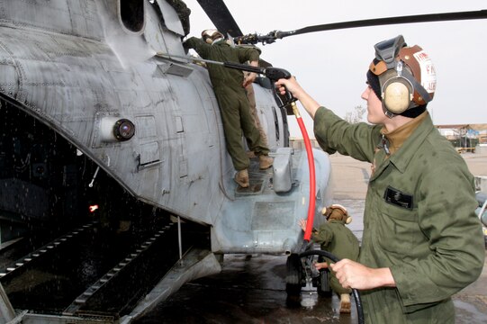 Cpl. Travis N. Ladegast sprays down a CH-46 Sea Knight helicopter Feb. 21 at Al Taqaddum, Iraq. Ladegast is a flight line mechanic and Rockford, Mich., native with Marine Medium Helicopter Squadron 268, Marine Aircraft Group 16, 3rd Marine Aircraft Wing. The Red Dragons received responsibility for casualty evacuation and general aviation support missions from HMM-161, MAG-16, 3rd MAW, Feb. 25.