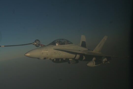 An F/A-18 Hornet receives fuel from a KC-130J Hercules through a hose during an aerial refueling mission high above Iraq, March 17. The enlisted crewmembers with Marine Aerial Refueler Transport Squadrons 352, Marine Aircraft Group 16 (Reinforced), 3rd Marine Aircraft Wing, are responsible for safely conducting Marine aerial refueling missions throughout Iraq.