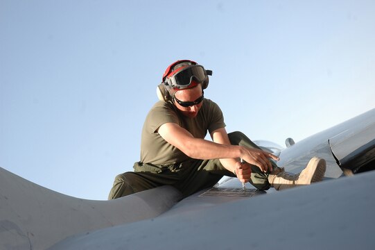Lance Cpl. Nicholas M. Aguilar uninstalls the flares dispenser from an AV-8B Harrier on the flight line at Al Asad, Iraq, July 10. The flare dispenser provides aircraft defensive countermeasures against surface-to-air missiles. Aguilar, an ordnance technician with Marine Attack Squadron 513, Marine Aircraft Group 16 (Reinforced), 3rd Marine Air Wing, and the rest of the ordnance shop, is responsible for ensuring that all Harriers leaving the air station are equipped with the necessary munitions.