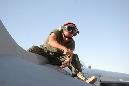 Lance Cpl. Nicholas M. Aguilar uninstalls the flares dispenser from an AV-8B Harrier on the flight line at Al Asad, Iraq, July 10. The flare dispenser provides aircraft defensive countermeasures against surface-to-air missiles. Aguilar, an ordnance technician with Marine Attack Squadron 513, Marine Aircraft Group 16 (Reinforced), 3rd Marine Air Wing, and the rest of the ordnance shop, is responsible for ensuring that all Harriers leaving the air station are equipped with the necessary munitions.