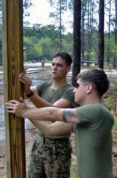 Lance Cpl. Kirstin Rawlins stages her bags on the flight line at Al Asad, Iraq, July 31, before flying to Camp Korean Village, Iraq, to train with 3rd Light Armored Reconnaissance Battalion, and begin her 30-day security cycle in the Lioness Program. Eight female Marines from different units within 3rd Marine Aircraft Wing volunteered for the Lioness Program to conduct security searches of women crossing into Iraq. Rawlins is a warehouse clerk with Marine Aircraft Group 16 (Reinforced), 3rd MAW, and a Lincoln, Ill., native.