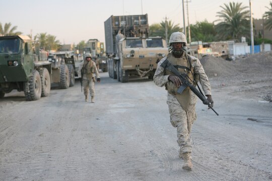 Private First Class Michael E. Jordan, a 23-year-old native of Detroit, patrols the interior of Combat Outpost Falcon shortly after he and his fellow Marines arrived to emplace over 300 concrete barriers June 26, 2006. The five Marines, a part of Combat Logistics Detachment 115, Combat Logistics Regiment 15, out of Camp Taqaddum, Iraq, aided the Army's 1st Brigade, 1st Armored Division in securing the combat outpost, a part of increased security operations in Southern Ramadi. (Official USMC photograph by Cpl. Daniel J. Redding. 060626-M-7799R-001. Released.)