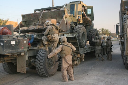 Marines arrive at Combat Outpost Falcon to emplace over 300 concrete barriers June 26, 2006. The five Marines, a part of Combat Logistics Detachment 115, Combat Logistics Regiment 15, out of Camp Taqaddum, Iraq, aided the Army's 1st Brigade, 1st Armored Division in securing the combat outpost, a part of increased security operations in Southern Ramadi. (Official USMC photograph by Cpl. Daniel J. Redding. 060626-M-7799R-005. Released.)