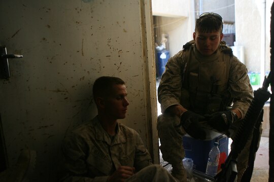 Marines take a moment to relax at Combat Outpost Falcon while emplacing over 300 concrete barriers June 26, 2006. The five Marines, a part of Combat Logistics Detachment 115, Combat Logistics Regiment 15, out of Camp Taqaddum, Iraq, aided the Army's 1st Brigade, 1st Armored Division in securing the combat outpost, a part of increased security operations in Southern Ramadi. (Official USMC photograph by Cpl. Daniel J. Redding. 060626-M-7799R-008. Released.)