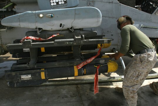 Lance Cpl. Micah E. Vogen loads an AGM-114 Hellfire missile aboard an AH-1W Super Cobra helicopter at Al Taqaddum, Iraq, March 25. Vogen and the ordnance division Marines with Marine Light Attack Helicopter Squadron 369, Marine Aircraft Group 16 (Reinforced), 3rd Marine Aircraft Wing, are responsible for quickly arming Cobras and UH-1N Hueys before they fly out on missions. Vogen is an aircraft ordnance technician and Kansas City, Mo., native.