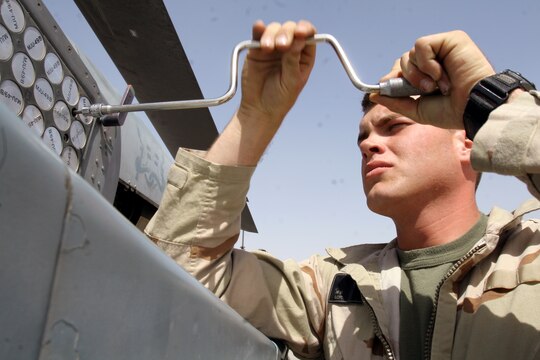 Lance Cpl. Nick W. Molthen unscrews an electronic countermeasure system flare box from its mount aboard an AH-1W Super Cobra at Al Taqaddum, Iraq, March 25. Molthen and the ordnance division Marines with Marine Light Attack Helicopter Squadron 369, Marine Aircraft Group 16 (Reinforced), 3rd Marine Aircraft Wing, are responsible for quickly arming Cobras and UH-1N Hueys before they fly out on missions. Molthen is an aircraft ordnance technician and Seattle native.