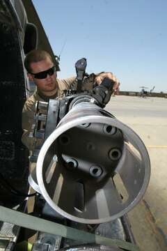 Lance Cpl. Justin W. Ahlers inspects a GAU-17/A Gatlin gun on a UH-1N Huey before a dismounted patrol escort flight May 11. Ahlers is a crew chief and Jefferson, Wis., native deployed with Marine Light Attack Helicopter Squadron 169, Marine Aircraft Group 16 (Reinforced), 3rd Marine Aircraft Wing.
