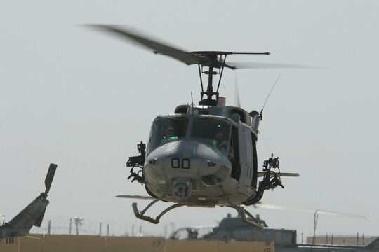 A UH-1N Huey helicopter taxis toward the flight line at Al Taqaddum, Iraq, May 11. The Cobra belongs to Marine Light Attack Helicopter Squadron 169, Marine Aircraft Group 16 (Reinforced), 3rd Marine Aircraft Wing. The squadron escorted a dismounted convoy through the streets and fields of Karma that afternoon.