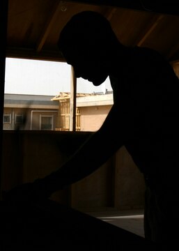 Lance Cpl. Thomas R. Hunter hammers nails while constructing a bench for his 'Gurus' woodshed May 13, 2006, at Al Asad, Iraq. Hunter, a native of Tacoma, Wash., is a combat engineer with Marine Wing Support Squadron 373, Marine Wing Support Group 37 (Reinforced), 3rd Marine Aircraft Wing. Hunter is augmented to Marine Wing Headquarters Squadron 3 for the duration of his deployment and serves as an engineer operations clerk.