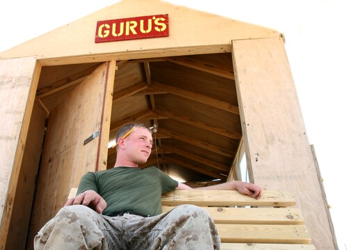 Lance Cpl. Thomas R. Hunter sits back in a bench that he made for his 'Gurus' woodshed May 16, 2006, in Al Asad, Iraq. Hunter, a native of Tacoma, Wash., is a combat engineer with Marine Wing Support Squadron 373, Marine Wing Support Group 37 (Reinforced), 3rd Marine Aircraft Wing. Hunter is augmented to Marine Wing Headquarters Squadron 3 for the duration of his deployment and serves as an engineer operations clerk.