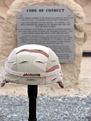 A display built by members of the 386th Expeditionary Security Forces Squadron honors Airman 1st Class Elizabeth Jacobson, who was killed while on a convoy near Camp Bucca, Iraq. Her vehicle was hit by an improvised explosive device on Sept. 28, 2005. She was the first female Airman killed in the line of duty supporting Operation Iraqi Freedom. (U.S. Air Force photo/Capt. Jeff Clark) 
