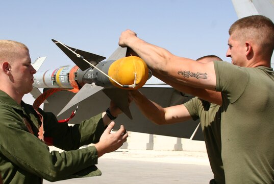 Lance Cpl. Robert Simpson (middle) loads ordnance on a Thunderbolt F/A-18C Hornet with the help of Lance Cpls. Daniel Johnson (left) and Daniel Jacob at Al Asad, Iraq, Sept. 19. Simpson, Johnson and Jacob are aircraft ordnance technicians with Marine Fighter Attack Squadron 251, Carrier Air Wing One, Carrier Strike Group Twelve. Simpson is a native of Woodsville, N.H., Johnson hails from Beaufort, S.C., and Jacob calls Pittsburgh home.