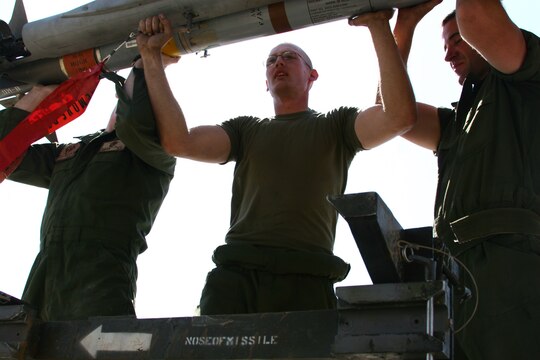 Cpl. Allen Greeley (center) loads ordnance on a Thunderbolt F/A-18C Hornet with the assistance of Lance Cpls. Daniel Johnson (left) and Daniel Jacob at Al Asad, Iraq, Sept. 19. Greeley, Johnson and Jacob are aircraft ordnance technicians with Marine Fighter Attack Squadron 251, Carrier Air Wing One, Carrier Strike Group Twelve. Greeley is a Phoenix, native, Johnson hails from Beaufort, S.C., and Jacob calls Pittsburgh home.