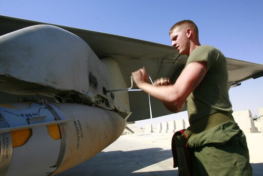 Lance Cpl. Robert Simpson tightens the bolt on the ordnance attached to an F/A-18C Hornet at Al Asad, Iraq, Sept. 19. Simpson is an aircraft ordnance technician with Marine Fighter Attack Squadron 251, Carrier Air Wing One, Carrier Strike Group Twelve. Simpson is a native of Woodsville, N.H.