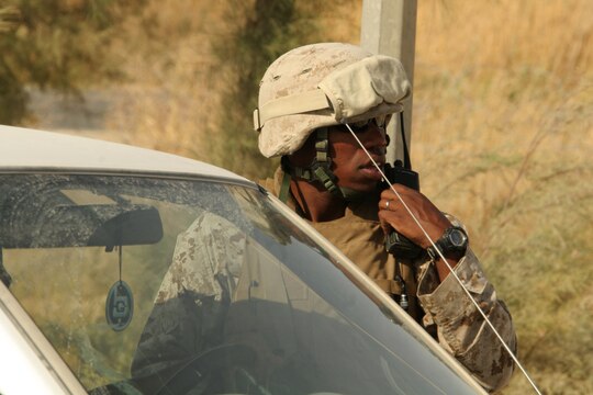 Sgt. Justin A. Hauser radios the guard shack to report a vehicle entering the Tactical Air Command Center compound at Al Asad, Iraq, Sept. 21. Hauser is the sergeant of the guard with TACC Security, Alpha Battery, 3rd Low Altitude Air Defense Battalion, Marine Wing Support Group 37 (Reinforced), 3rd Marine Aircraft Wing (Forward). He is a 28-year-old native of Albany, N.Y.