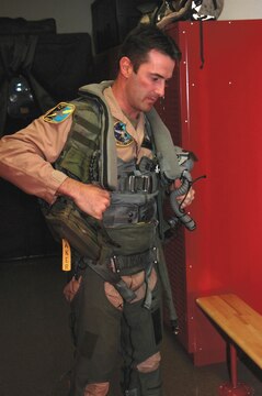 British Royal Air Force Squadron Leader Michael Baker suit suits up in his flight suit at Marine Attack Squadron 513?s hangar here Monday. Baker, a pilot for VMA-513, is part of the pilot exchange program in which, a pilot spends two or three years stationed with a different country to learn their methods and tactics.