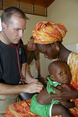 Maj. (Dr.) Darin Brimhall performs a well baby exam while Master Sgt. Rick Brewer assists as part of Shared Accord 07 June 16 to 28 in Linguere, Senegal. Major Brimhall is a physician assigned to the 752nd Medical Squadron, and Sergeant Brewer is a medical technician from the 445th Aeromedical Staging Squadron. (U.S. Air Force photo/Master Sgt. Chance C. Babin) 
