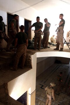 Lance Cpl. Dustin R. Crandell, squad leader, 2nd Squad, 3rd Platoon, Charlie Company, patrols through a wadi in Haqlaniyah looking for a weapons cache June 13, during a contact patrol.