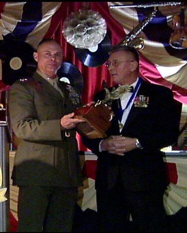 MARINE CORPS BASE CAMP LEJEUNE, N.C. - Major General Robert C. Dickerson, base commanding general, receives the C.A. McKinney award Feb. 11 at Sywanyck's Scarlet and Gold Traditions restaurant during a ceremony hosted by the Noncommissioned Officers Association. Retired Sgt. Maj. Joe Houle, a former award winner and current executive for the NCOA, presented Dickerson the award along with the nights other winner, retired Air Force Chief Master Sergeant Richard Schneider.  "Major General Dickerson has been taking care of Marines and Sailors for many years now," said Houle. "He's a problem solving kind of guy. If you go to him with a problem, he's going to fix it." (Official Marine Corps photo by Cpl. Patrick McHugh)