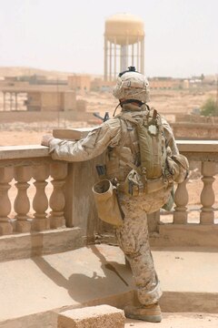 A Marine assigned to 1st Squad, 3rd Platoon, Bravo Company, 1st Battalion, 3rd Marine Regiment, looks into the distance for anything that may harm the Marines in his squad.
