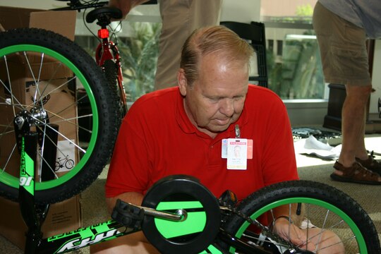 Steve Leavitt of BAE Systems' Communications Division, assembles one of the "Bikes for Tykes" for the Marine Corps Reserve's Toys for Tots annual drive Saturday, Nov 17, 2007 at the First Hawaiian Bank Center, Honolulu.  BAE Systems employees donated the money to purchase the bicycles, and donated their time to assemble them.  All the toys donated in Hawaii stay in Hawaii to benefit less fortunate keiki.
