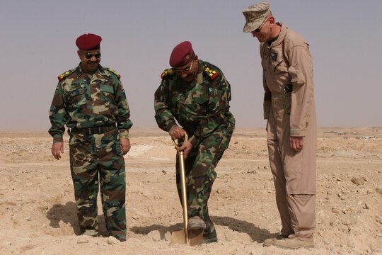Iraqi Staff Brig. Gen. Abdullah Mohammad Bayder al-Jabouri, the commanding general of the 7th Iraqi Infantry Division, completes the ceremonial first dig during a ground-breaking ceremony for a new Divisional Training Center here today. Abdullah is flanked by Iraqi Staff Brig. Gen. Amir Jassam Mohammed al-Dulaimi, the deputy commanding general for the 7th Iraqi Infantry Division and by Marine Brig. Gen. Randolph D. Alles, the commanding general for 3rd Marine Aircraft Wing (Forward). The DTS will serve as ongoing individual and small unit training for the 7th Iraqi Army Division and subordinate units stationed here.