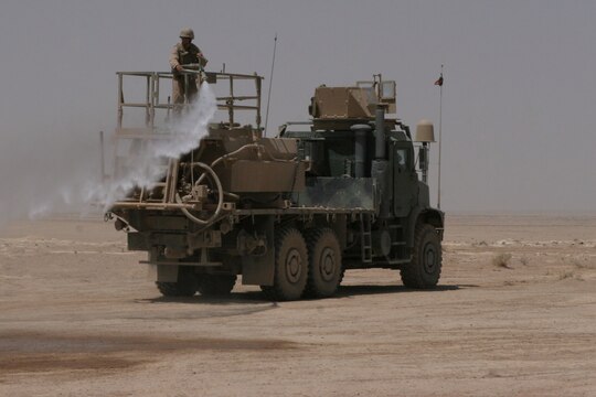A Marine with Marine Wing Support Squadron 172, 3rd Marine Aircraft Wing (Forward), sprays a layer of "rhino snot" on to the ground during the construction of a helicopter-landing zone. Rhino snot, a soil-stabilizer which hardens the dirt, preventing excessive kick-up when aircraft land, is a key step in the construction and improvement of HLZs. Building new landing zones and modifying existing ones throughout the Anbar Province are just two of the many jobs the "Firebirds" do on a daily basis.