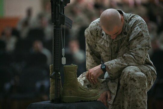 CAMP FALLUJAH, Iraq (August 16, 2008) - Marines with Maintenance Company, Combat Logistics Battalion 1, 1st Marine Logistics Group, came to pay their final respects to Cpls. Adam T. McKiski and Stewart S. Trejo during a memorial service Aug. 16. (Photo by Cpl. Tyler B. Barstow)