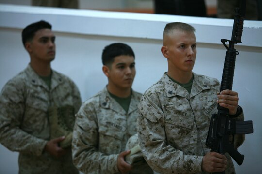 CAMP FALLUJAH, Iraq (August 16, 2008) - Cpl. Christopher L. Riley, a small arms repair technician with Maintenance Company, Combat Logistics Battalion 1, 1st Marine Logistics Group leads the memorial detail during the service for Cpls. Adam T. McKiski and Stewart S. Trejo Aug. 16. (Photo by Cpl. Tyler B. Barstow)