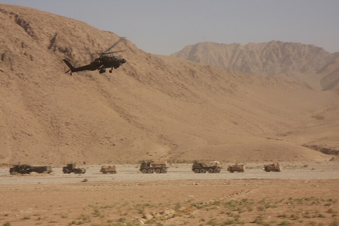 U.S. Marine Lance Cpl. Chad J. Pulliam, photographer, TF 2/7, captures a U.S. Army attack helicopter providing aerial security for a British convoy carrying a hydro-electric turbine to the Kajaki Dam in the Helmand Province of Afghanistan, Aug. 30.  (U.S. Marine Corps photo by Cpl. Chad J. Pulliam)