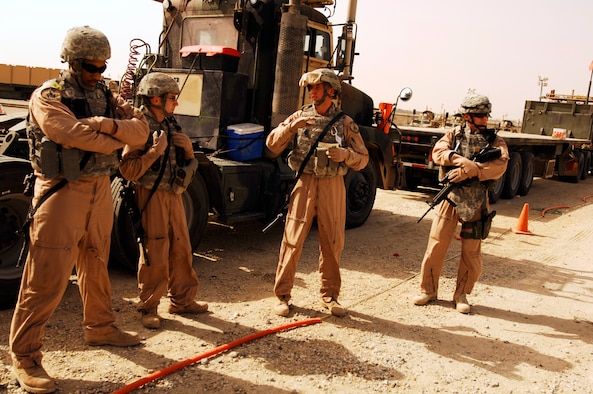 SOUTHWEST ASIA -- Tech. Sgt. Scott Neu (center), a convoy commander from the 586th Expeditionary Logistics Readiness Squadron, 70th Medium Truck Detachment, gives a safety briefing before leading a recent convoy from an Army camp in the Persian Gulf Region. The Airmen of the 70th and 424th MTDs assigned to the 586th ELRS are in-lieu-of forces supporting the Army Support Line-Haul Convoy movements in and out of Iraq. (U.S. Air Force photo/ Staff Sgt. Patrick Dixon) 
