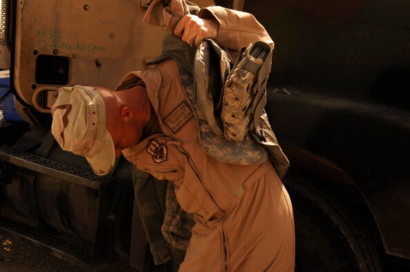 SOUTHWEST ASIA -- Technical Sgt. Scott Neu, a convoy commander from the 586th Expeditionary Logistics Readiness Squadron, 70th Medium Truck Detachment, gears up before leading a recent convoy from an Army camp in the Persian Gulf Region. The Airmen of the 70th and 424th MTDs assigned to the 586th ELRS are in-lieu-of forces supporting the Army Support Line-Haul Convoy movements in and out of Iraq. Sergeant Neu is deployed from Eglin Air Force Base, Fla.  (U.S. Air Force photo/ Staff Sgt. Patrick Dixon)
