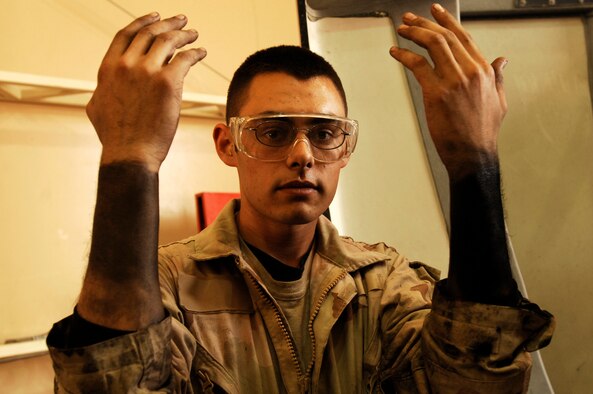 SOUTHWEST ASIA -- Senior Airman Ryan Duncan, a vehicle maintainer deployed to the 586th Expeditionary Logistics Readiness Squadron, 70th Medium Truck Detachment, shows the grease marks on his arms from working on M915A3 tractor-trailer trucks during scheduled maintenance recently at an Army camp in the Persian Gulf Region. The Airmen of the 70th and 424th MTDs assigned to the 586th ELRS are in-lieu-of forces supporting the Army Support Line-Haul Convoy movements in and out of Iraq.  Airman Duncan is deployed from the 97th Logistics Readiness Squadron, Altus Air Force Base, Okla. (U.S. Air Force photo/ Staff Sgt. Patrick Dixon) (U.S. Air Force photo/ Staff Sgt. Patrick Dixon) 