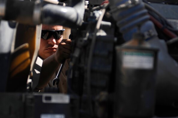 SOUTHWEST ASIA -- Staff Sgt. Adam Davis, a vehicle maintainer deployed to the 586th Expeditionary Logistics Readiness Squadron, 70th Medium Truck Detachment, works on the engine of a M915A3 tractor-trailer truck during scheduled maintenance recently at an Army camp in the Persian Gulf Region.  The Airmen of the 70th and 424th MTDs assigned to the 586th ELRS are in-lieu-of forces supporting the Army Support Line-Haul Convoy movements in and out of Iraq. Sergeant Davis is deployed from the 5th Logistics Readiness Squadron, Minot Air Force Base, N.D. (U.S. Air Force photo/ Staff Sgt. Patrick Dixon)