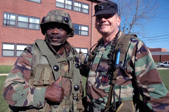 Chaplain (Maj.) Harold B. Owens, from the Ohio Air National Guard in Toledo, and Chaplain (Maj.) Thomas B. Porter, U.S. Air Force Expeditionary Center chaplain, stop for a photo during training in the Advanced Contingency Skills Course 08-4 April 15, 2008, at Fort Dix, N.J.  Both chaplains are graduates of Birmingham (Ala.) Southern College and chaplains in the Air Force.  They met up somewhat unexpectedly during the ACST while Chaplain Porter was teaching a class.  (U.S. Air Force Photo/Tech. Sgt. Scott T. Sturkol)