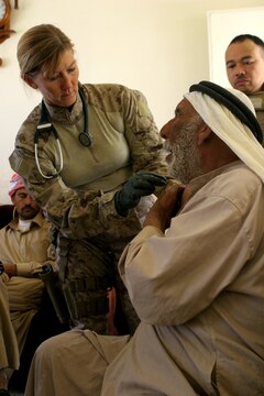 (May 15, 2008) ? Navy Lt. Anne M. Lopez, the medical officer-in-charge for Marine Wing Support Squadron 172, 3rd Marine Aircraft Wing (Forward), checks the vital signs of an Iraqi man during a cooperative medical engagement here May 15, 2008. (U.S. Marine Corps Photo by: Cpl. Jessica Aranda) 080515-M-8776A-002