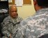 Army Col. (Dr.) Augustin Gomez speaks with a Soldier in the Patriot Clinic at Joint Base Balad, Iraq, Nov. 6. Gomez, a psychiatrist with the Army Reserve's 1835th Medical Detachment, specializes in treatment of post-traumatic stress disorder and works closely with the Air Force Mental Health Clinic to ensure patients with PTSD and traumatic brain injuries receive proper treatment. The 1835th CSCT is deployed from Denver. (U.S. Air Force photo/Staff Sgt. Don Branum)
