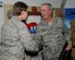 SOUTHWEST ASIA -- Senior Master Sgt. Edgar Newell, 380th Expeditionary Force Protection superintendent, thanks 2nd Lt. Sarah Rothlisberg after she presented him a plaque during a tribute at the start of the day's first shift here Nov. 8. Sergeant Newell is ending his last deployment prior to his retirement after nearly 40 years of military service. (U.S. Air Force photo by Tech. Sgt. Christopher A. Campbell)