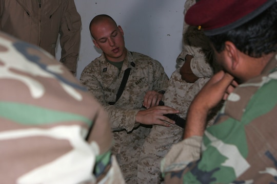 FORWARD OPERATING BASE MUDAYSIS, Iraq (Oct. 14, 2008) ? Seaman Devin L. Turner, a corpsman with Surgical Company, 1st Maintenance Battalion (-) (Reinforced), 1st Marine Logistics Group, applies a tourniquet to his fellow corpsmen during a Joint Medical Training Course with the Iraqi Army here, Oct. 14. The two Corpsmen taught basic medical classes to 25 Iraqi Soldiers to ensure they have the capability to save people who have life-threatening injuries. ?We?re here to increase the Iraqi Soldiers? medical knowledge,? said Turner, 25, from Fresno, Calif. ?This is bringing the country of Iraq one step closer to being able to operate on their own.? (Photos by Lance Cpl. Jacob A. Singsank)